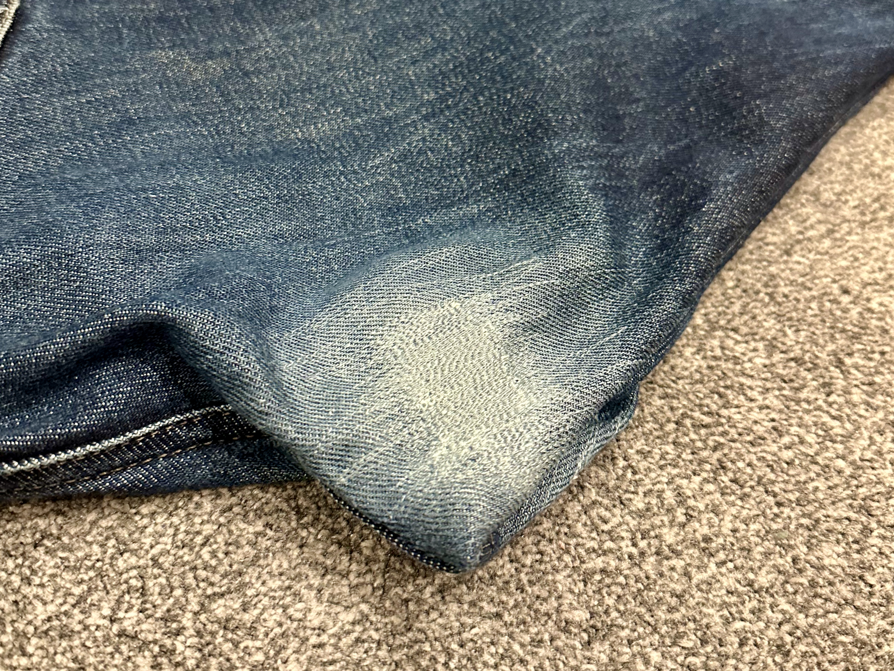 Photo of the crutch area of some jeans that have been paired with colour-matched stitching on the worn part of the denim